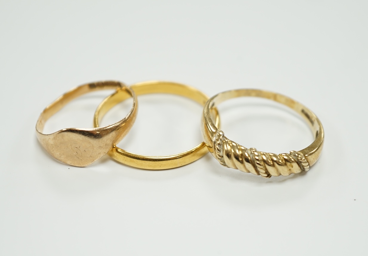 A 22ct gold wedding band, 3.4 grams, a 9ct gold signet ring, 16 grams and a yellow metal ring.